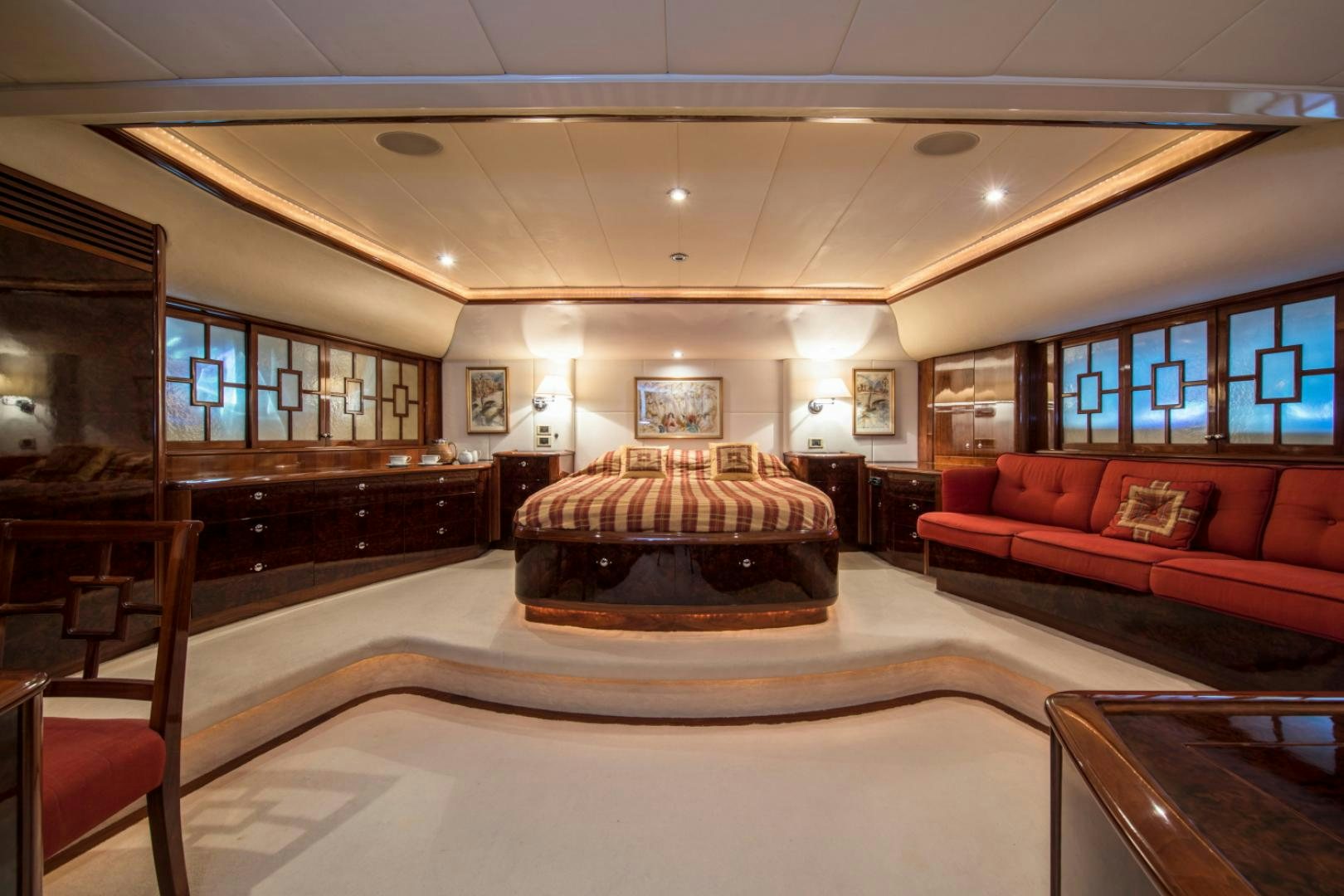 a large room with a couch and a table aboard SOVEREIGN Yacht for Sale