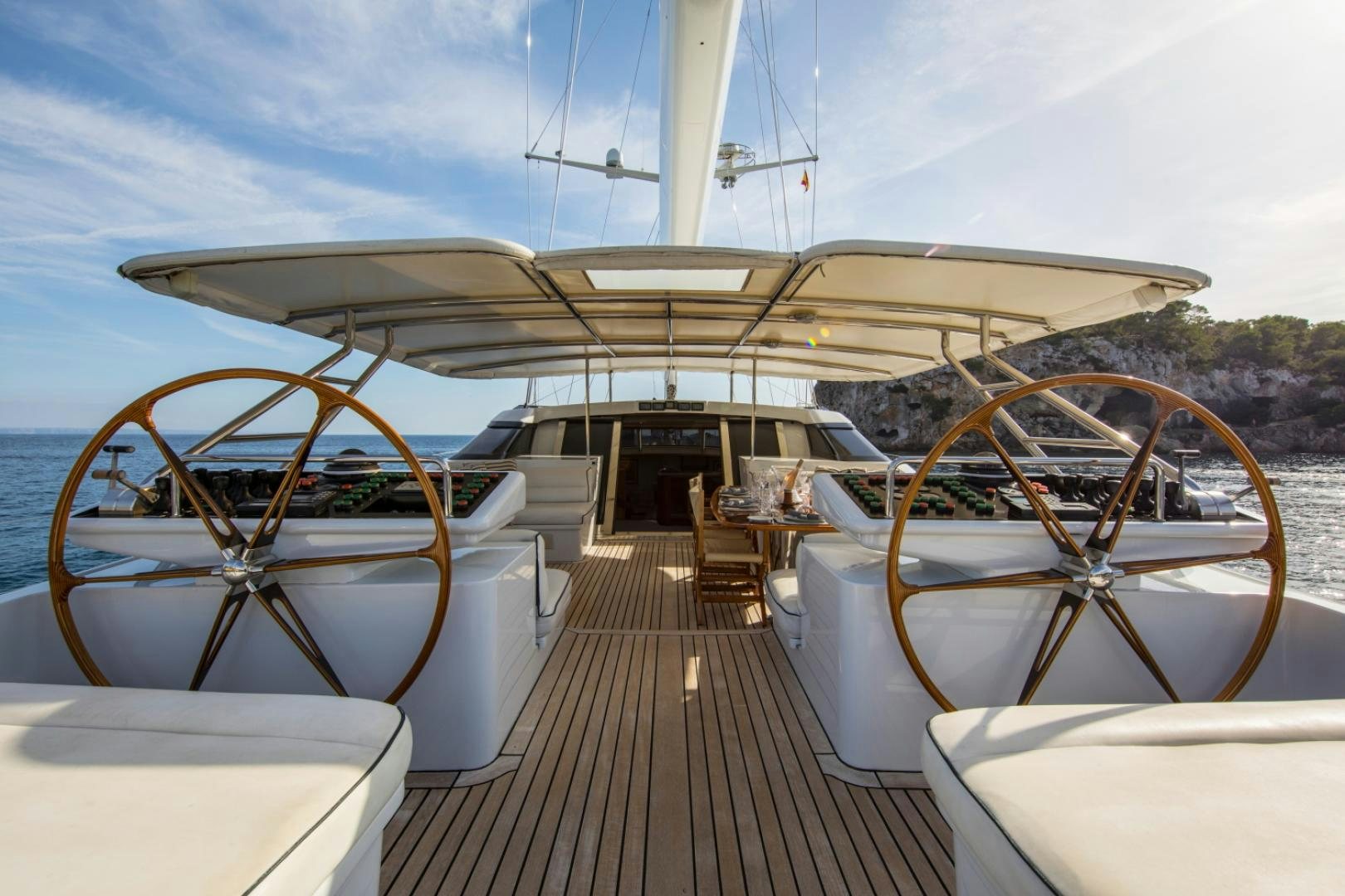 a large white building with a large wheel and a large wheel on a wooden deck aboard SOVEREIGN Yacht for Sale