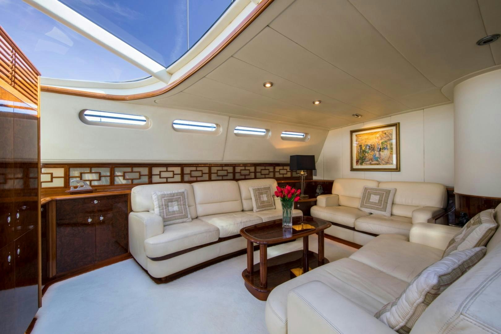 a living room with a couch and a coffee table aboard SOVEREIGN Yacht for Sale
