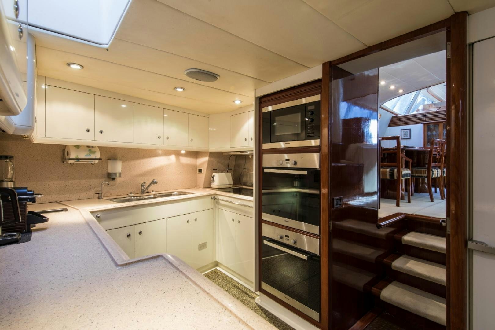 a kitchen with a glass door aboard SOVEREIGN Yacht for Sale