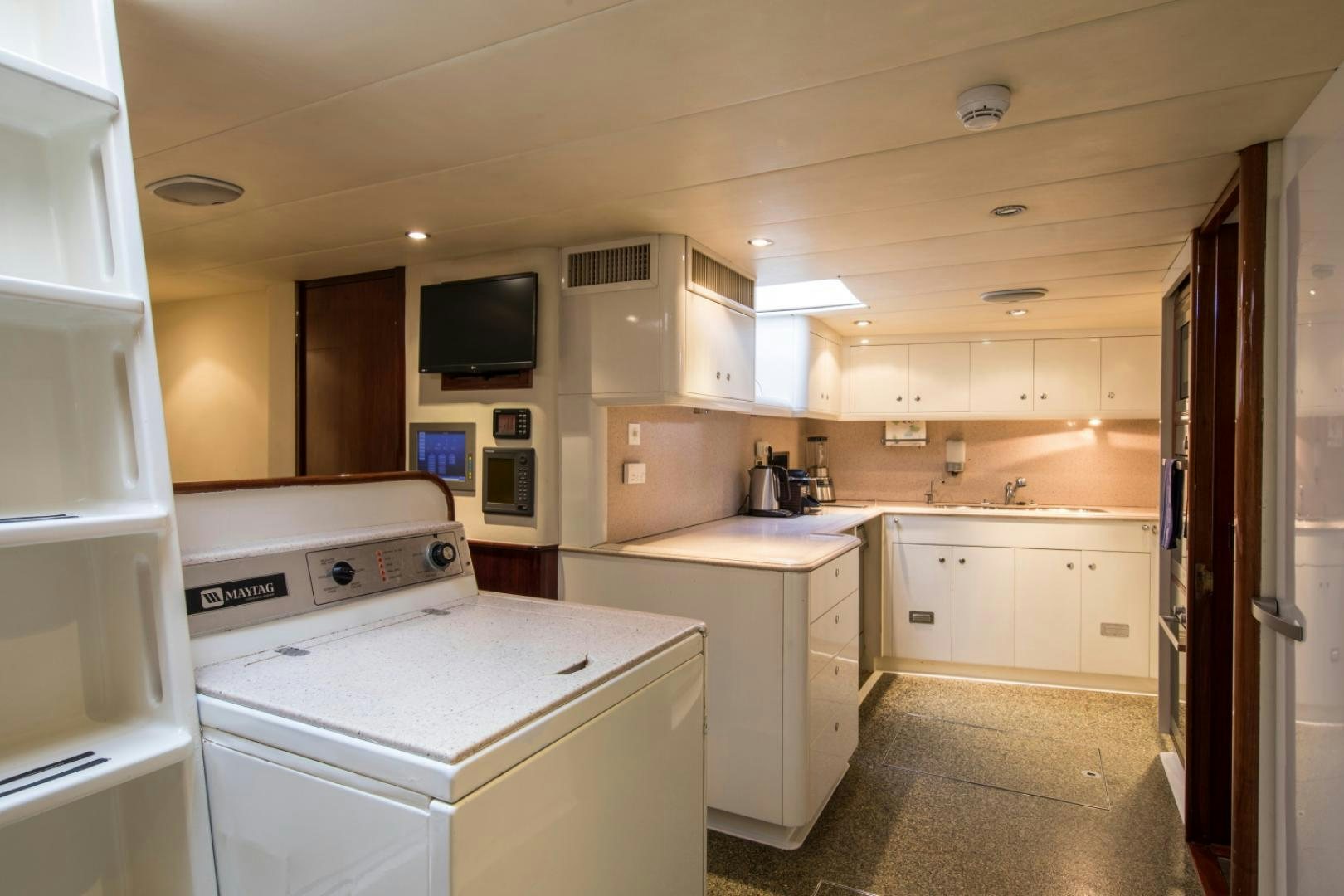 a kitchen with white appliances aboard SOVEREIGN Yacht for Sale