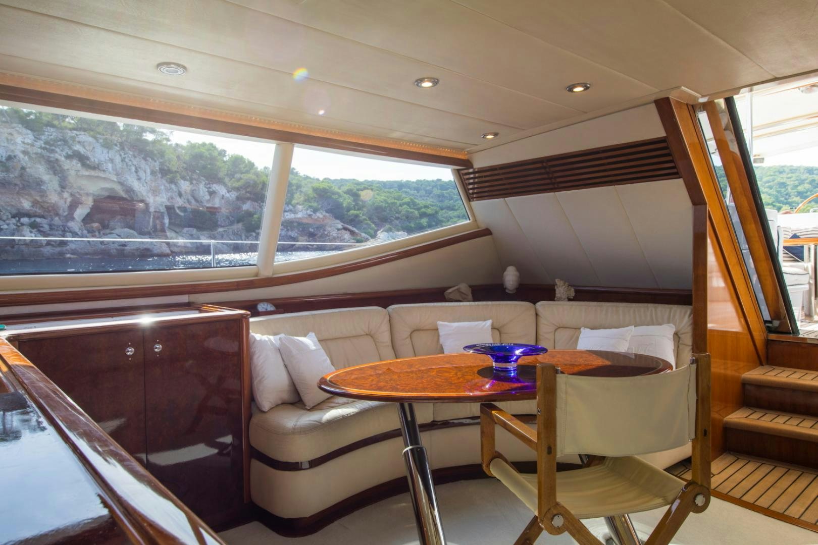 a table and chairs in a room aboard SOVEREIGN Yacht for Sale