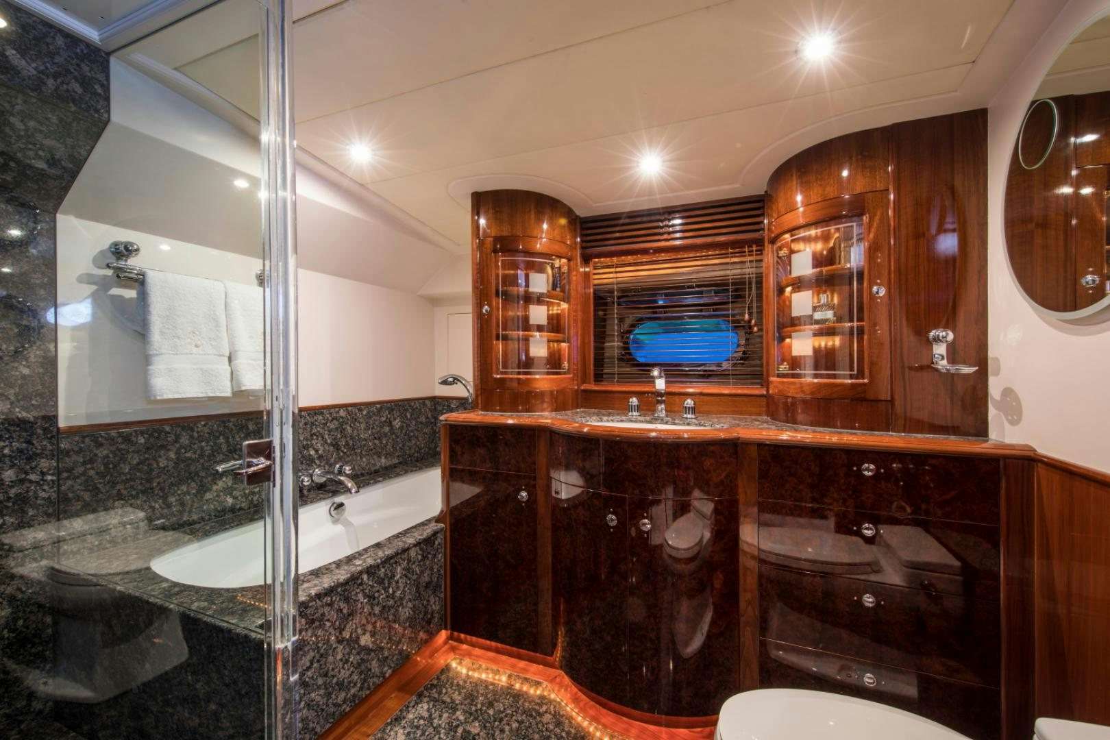 a bathroom with a large glass shower aboard SOVEREIGN Yacht for Sale