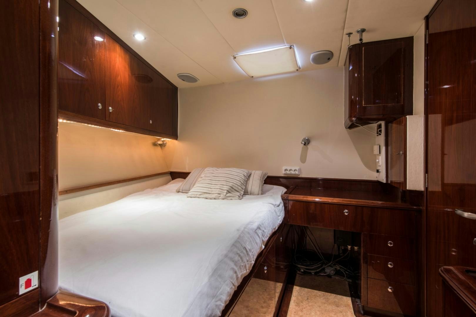 a room with a bed and a desk aboard SOVEREIGN Yacht for Sale