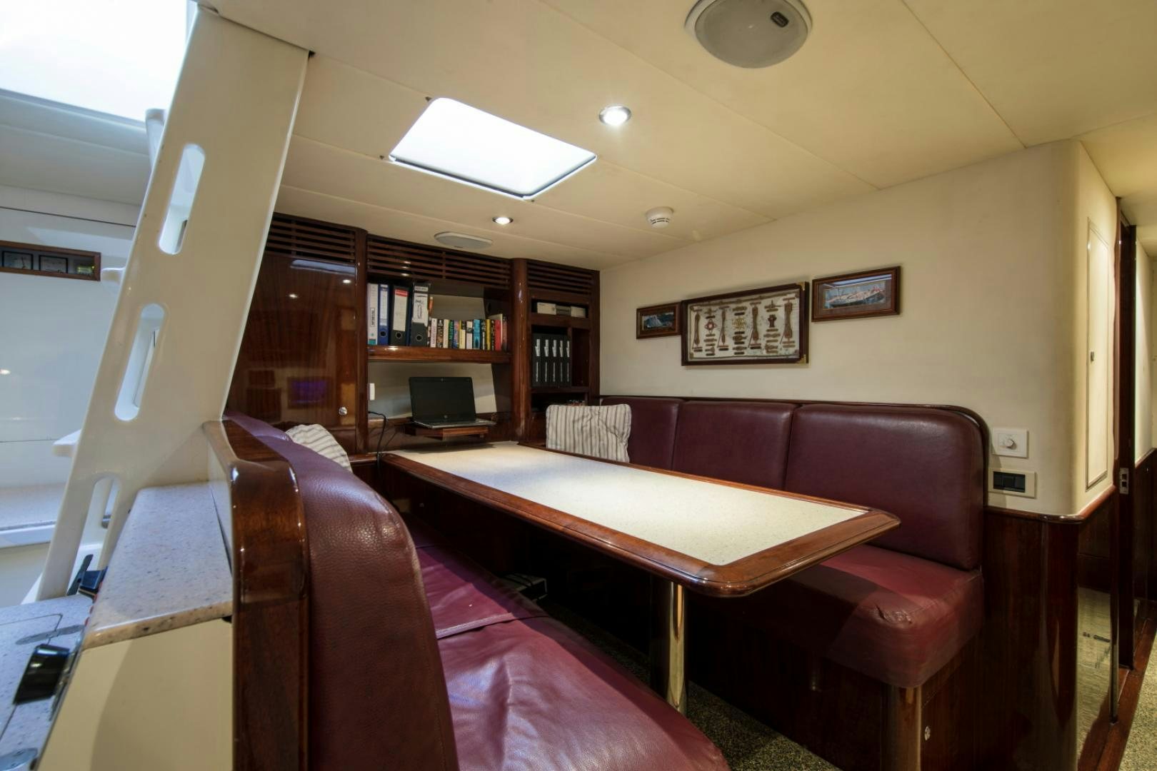 a room with a couch and a table aboard SOVEREIGN Yacht for Sale