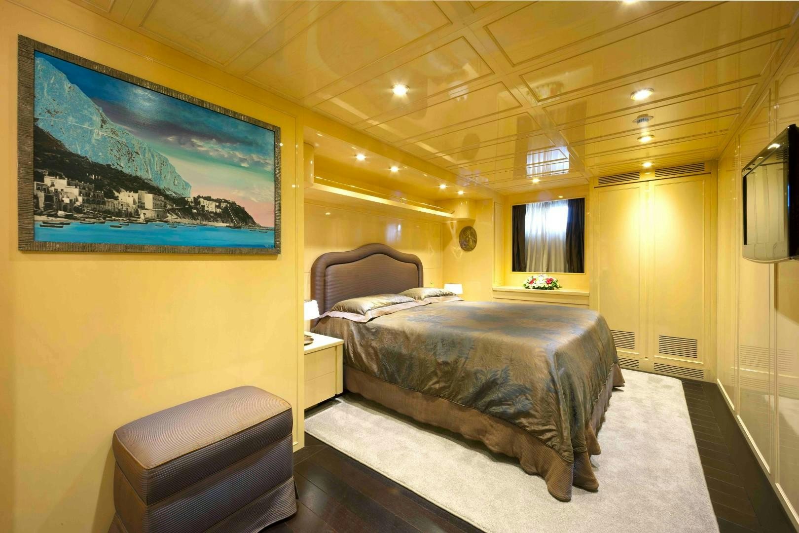 a bedroom with a large bed aboard DISCO VOLANTE Yacht for Sale