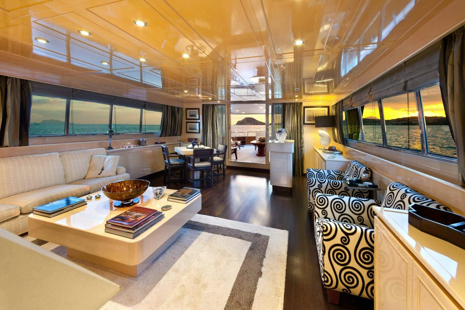a living room with a large window aboard DISCO VOLANTE Yacht for Sale