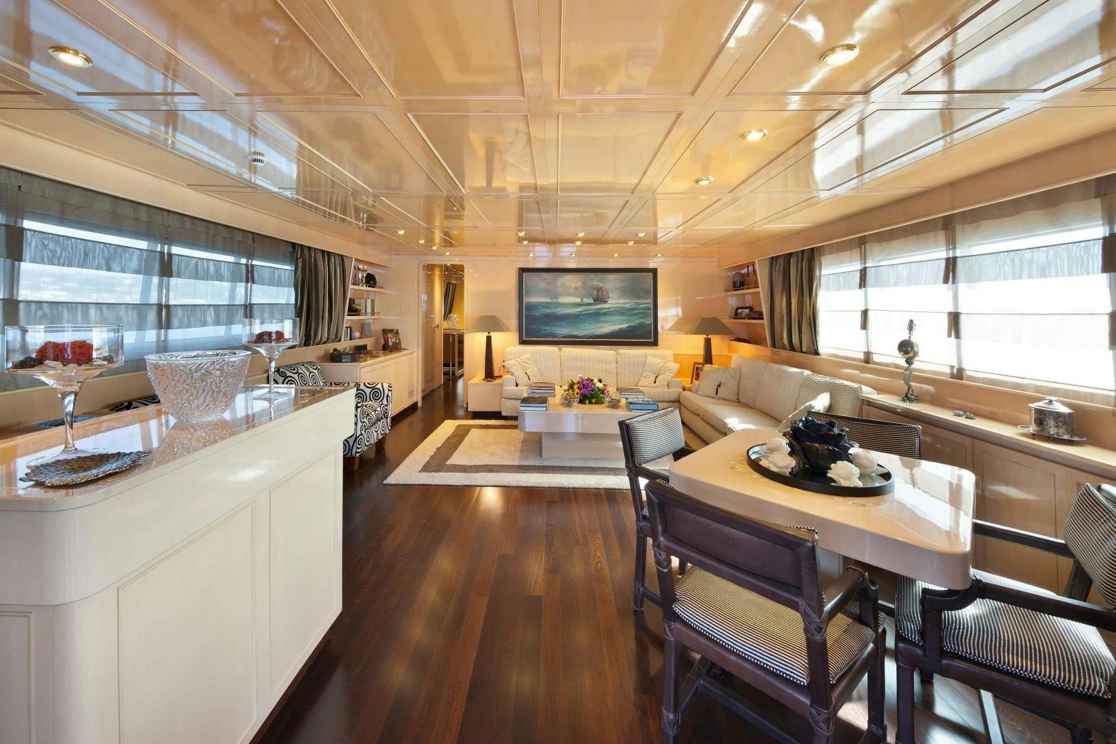 a room with a table chairs and a tv aboard DISCO VOLANTE Yacht for Sale
