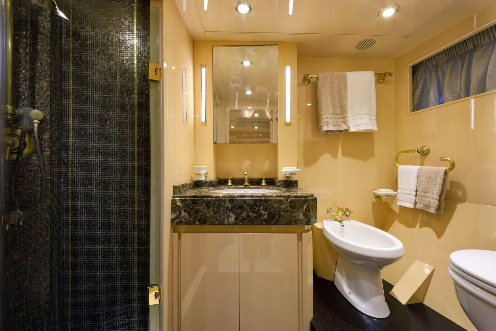 a bathroom with a marble counter top aboard DISCO VOLANTE Yacht for Sale
