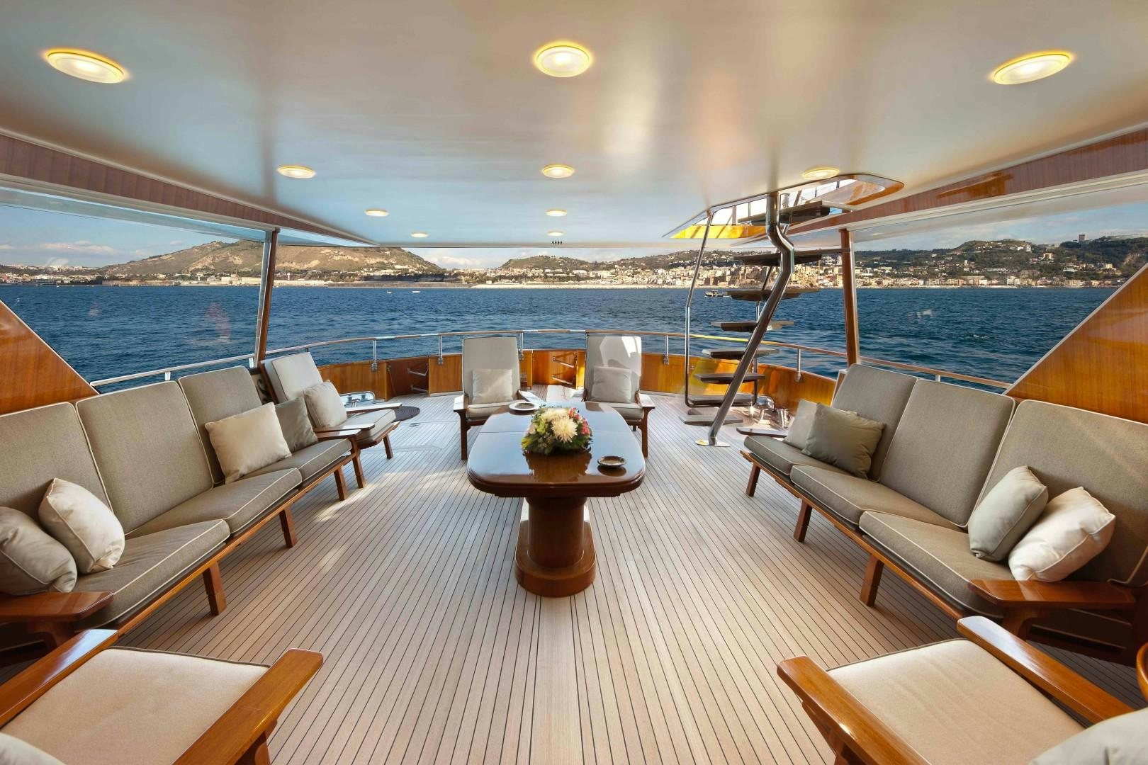 a large living room with a view of the ocean and the city aboard DISCO VOLANTE Yacht for Sale