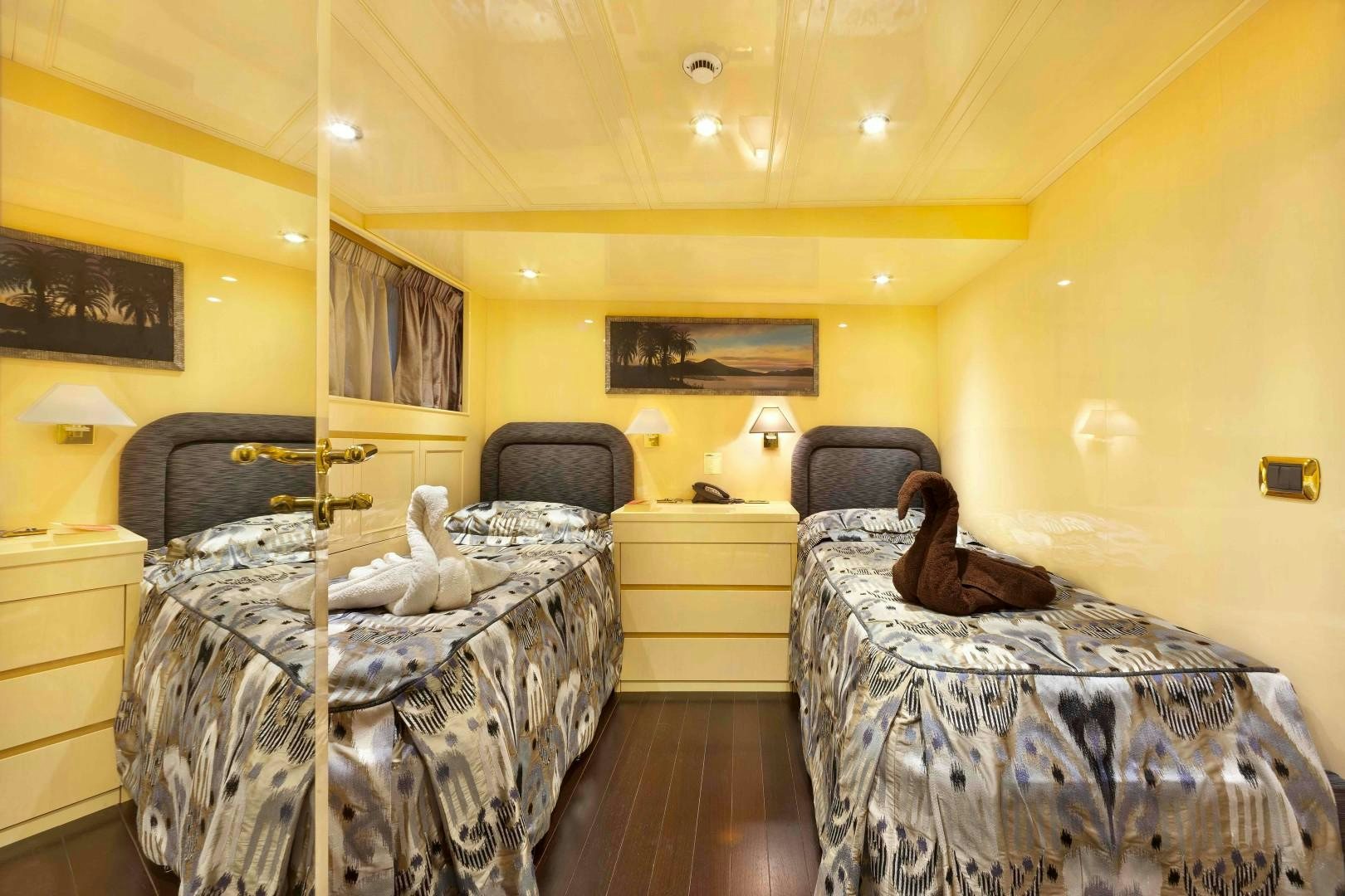a bedroom with two beds aboard DISCO VOLANTE Yacht for Sale