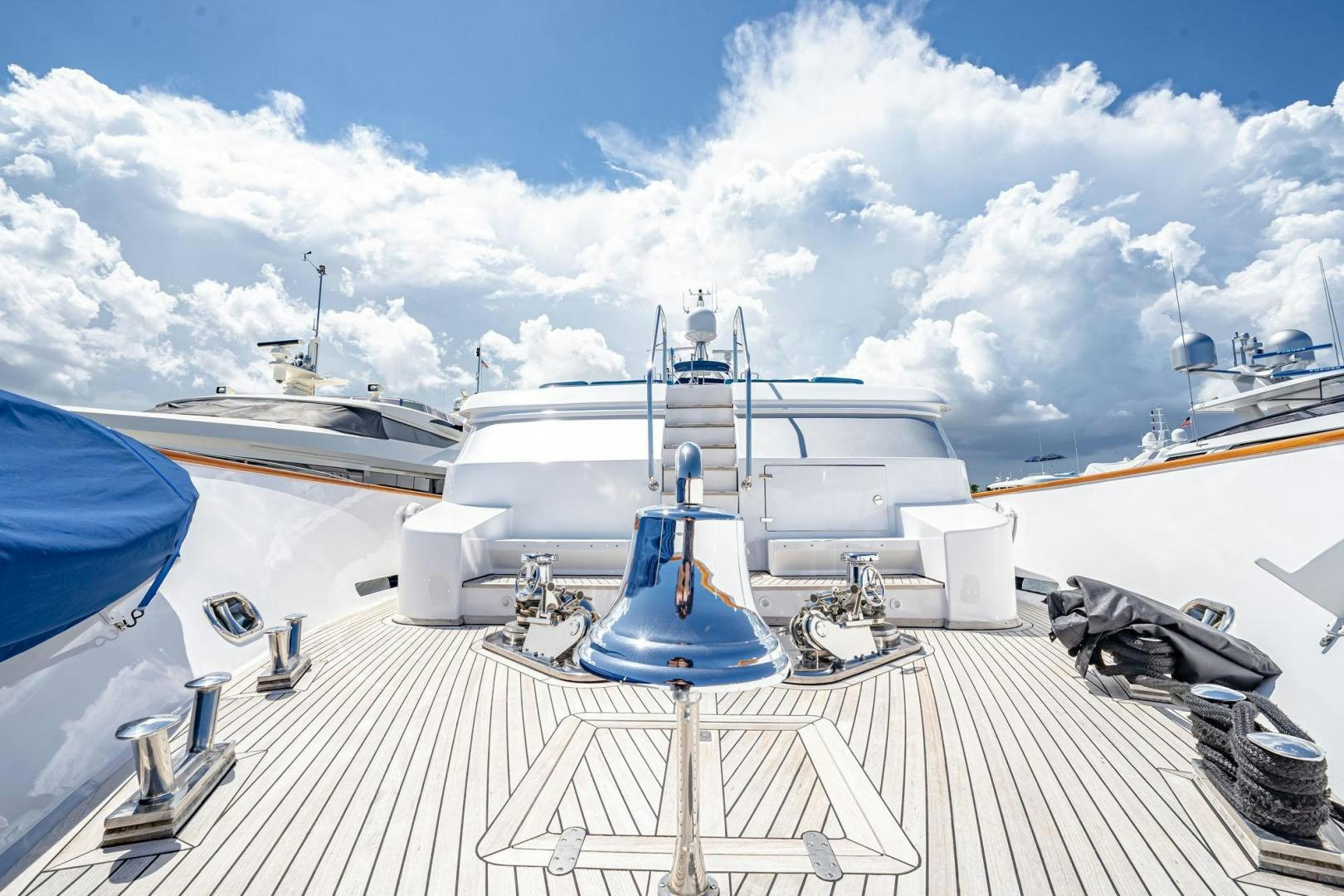 a deck with a boat and a deck with a railing and blue sky aboard SHALIMAR Yacht for Sale