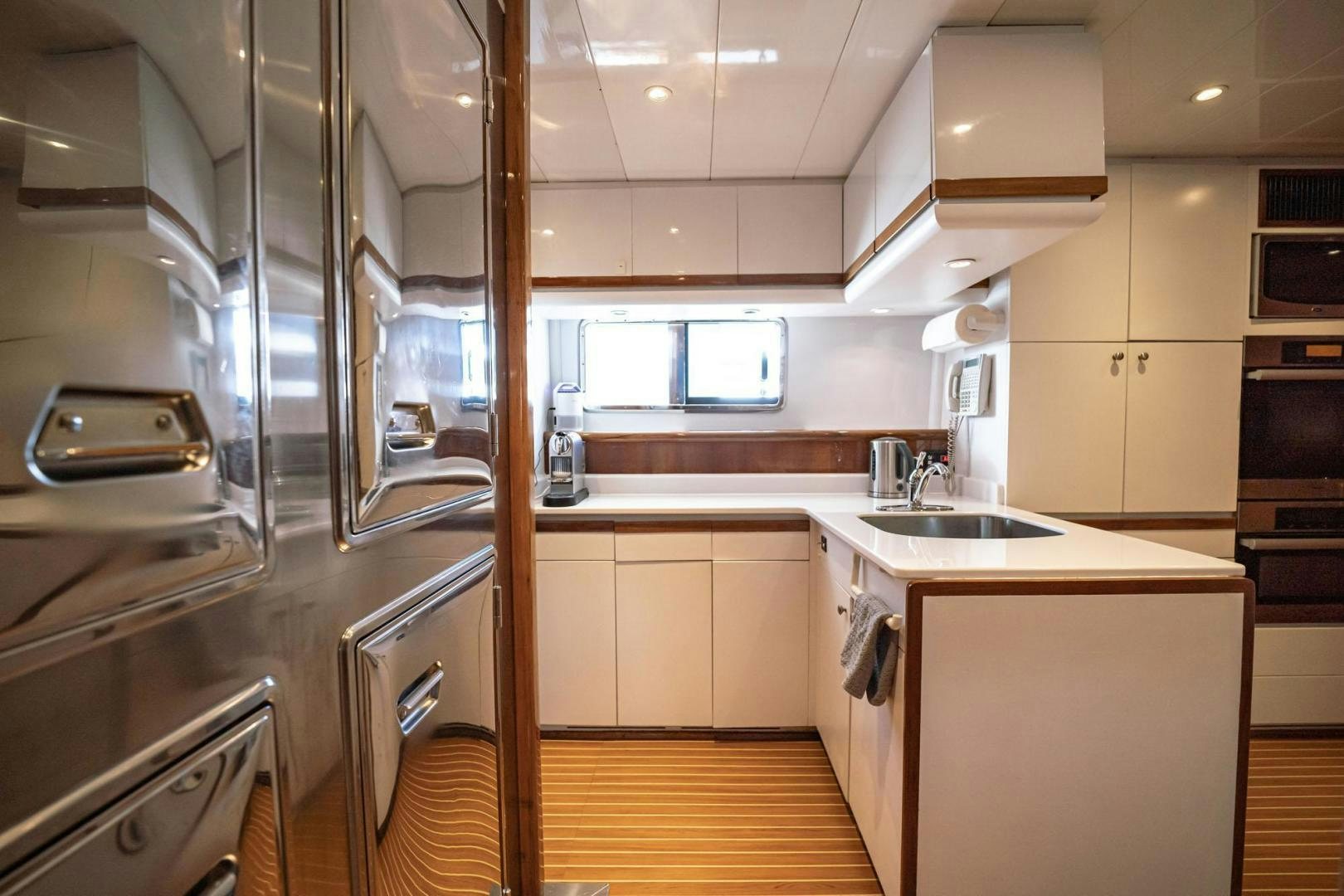 a kitchen with a stainless steel refrigerator aboard SHALIMAR Yacht for Sale