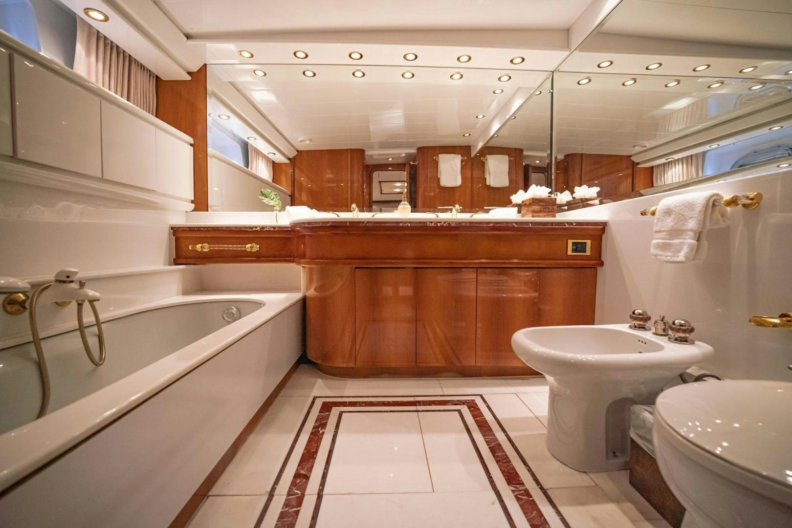 a bathroom with a tub sink and toilet aboard SHALIMAR Yacht for Sale