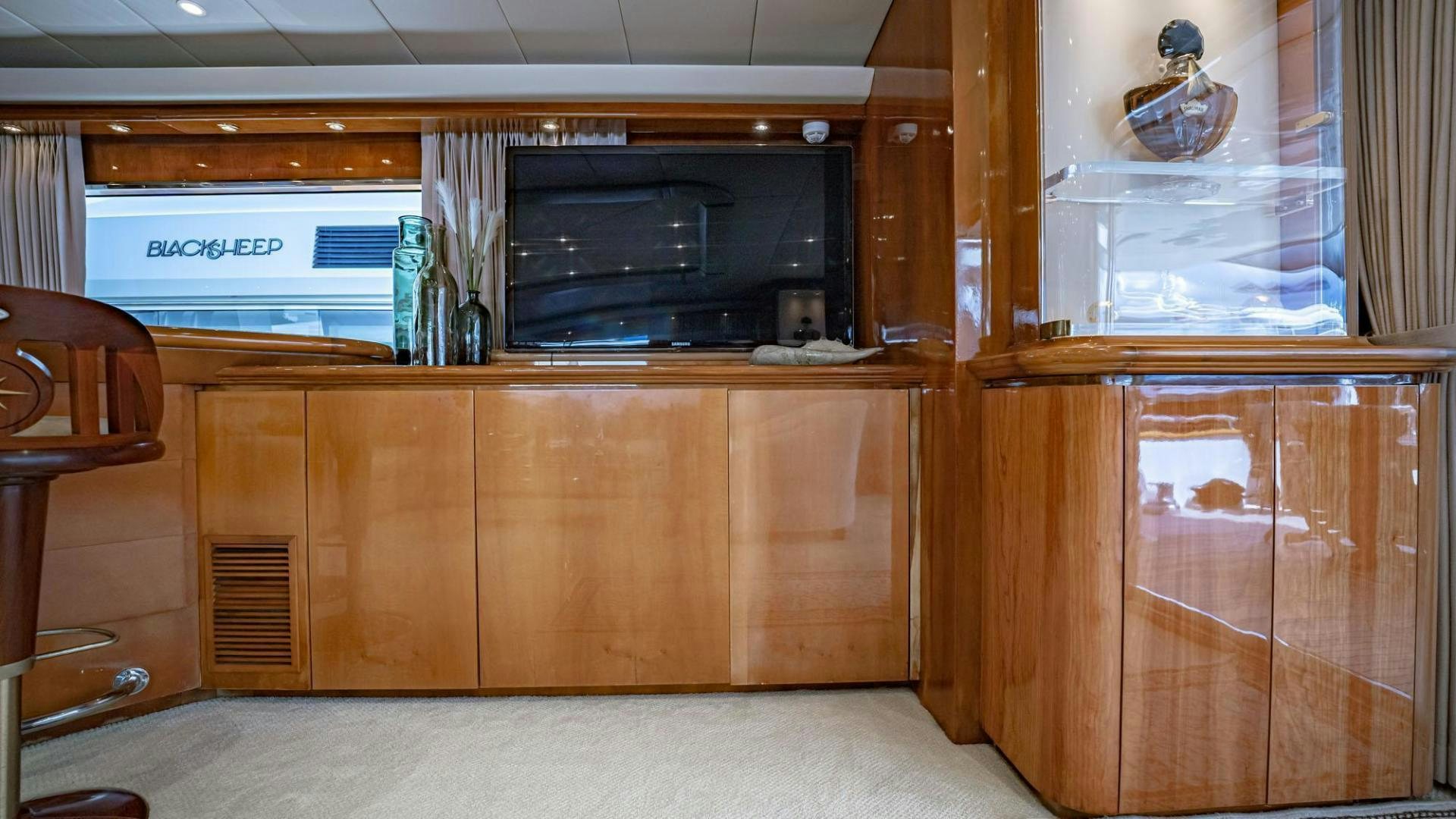 a room with wooden cabinets and a television aboard SHALIMAR Yacht for Sale
