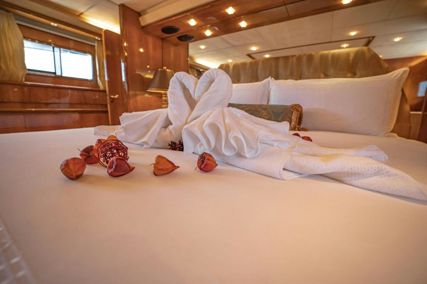 a bed with white sheets and pillows aboard SHALIMAR Yacht for Sale