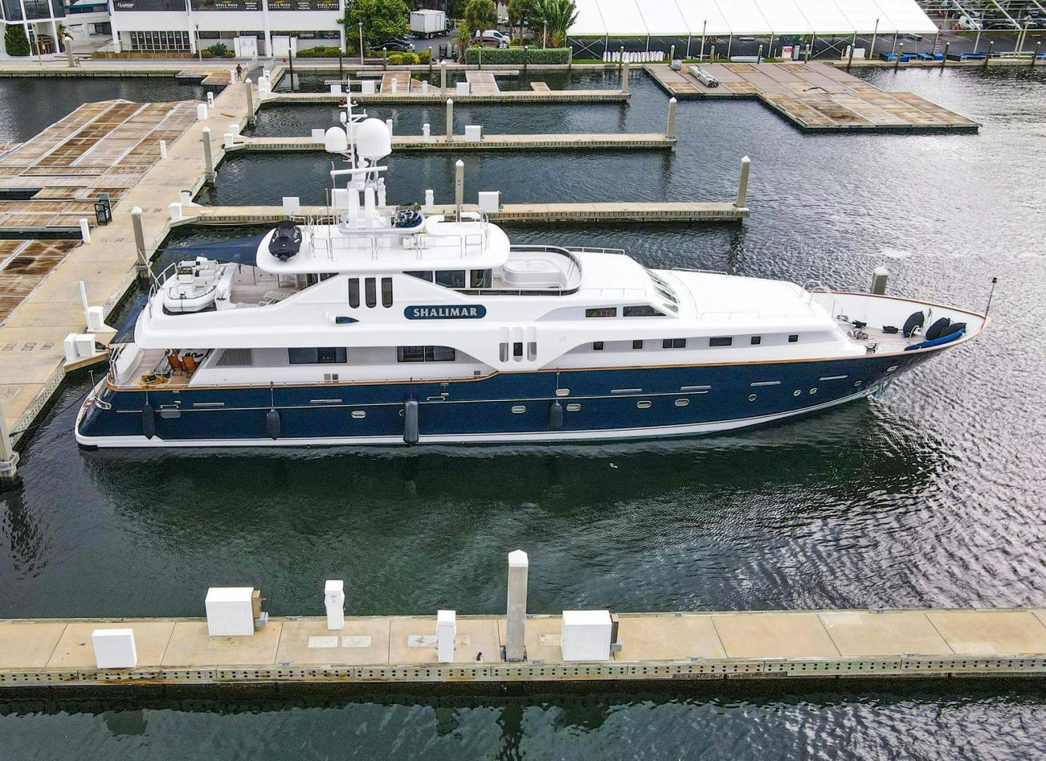 a large white boat in a harbor aboard SHALIMAR Yacht for Sale