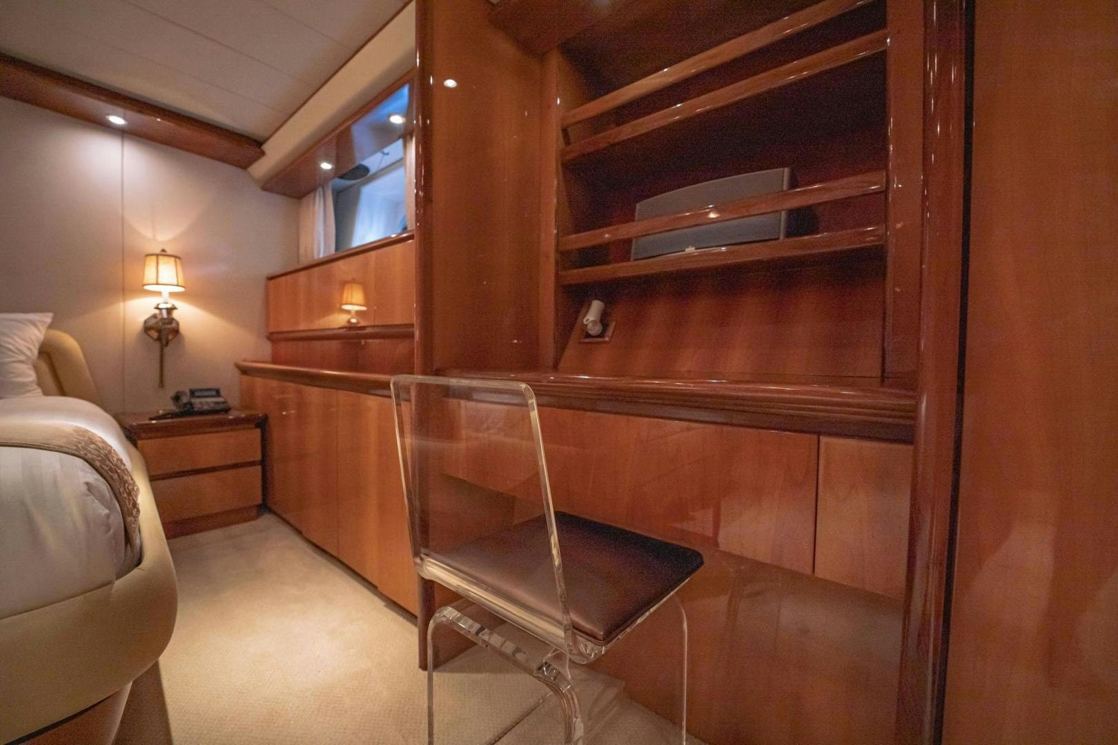 a bedroom with a bed and a chair aboard SHALIMAR Yacht for Sale