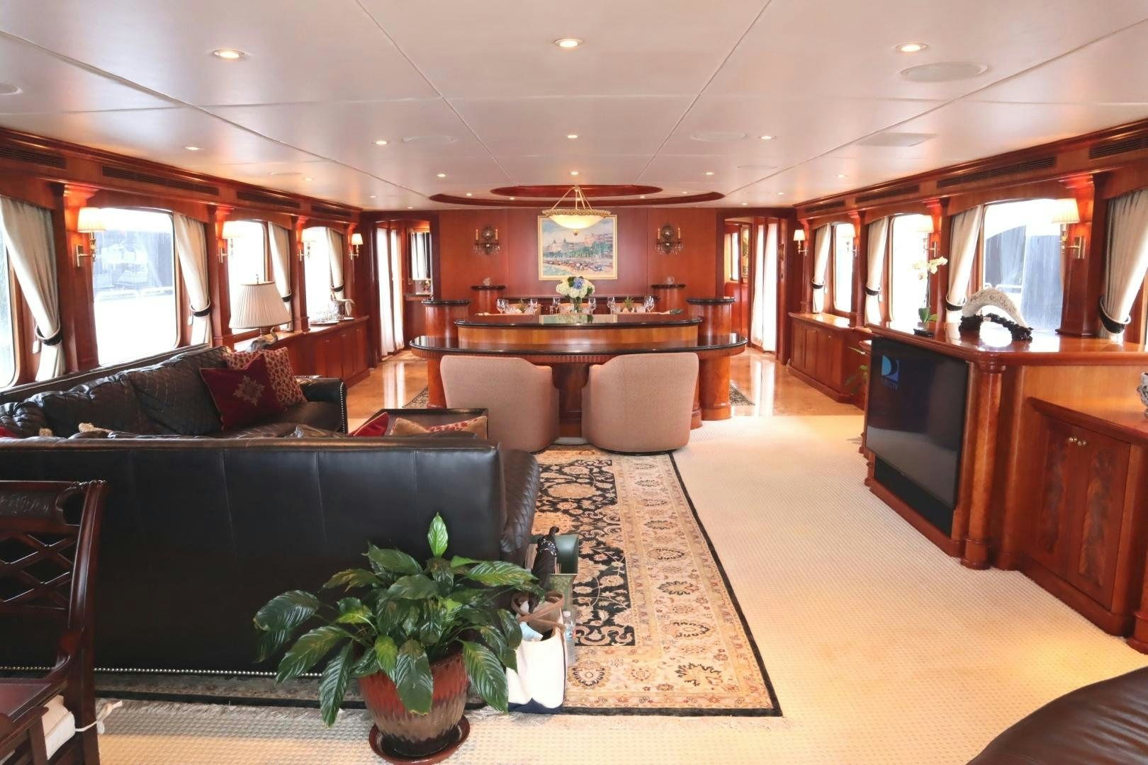 a living room with a table and couches aboard ELIZABETH Yacht for Sale