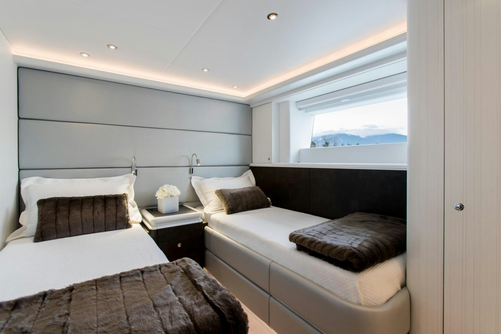 a room with a bed and a window aboard CRESCENT 117 Yacht for Sale