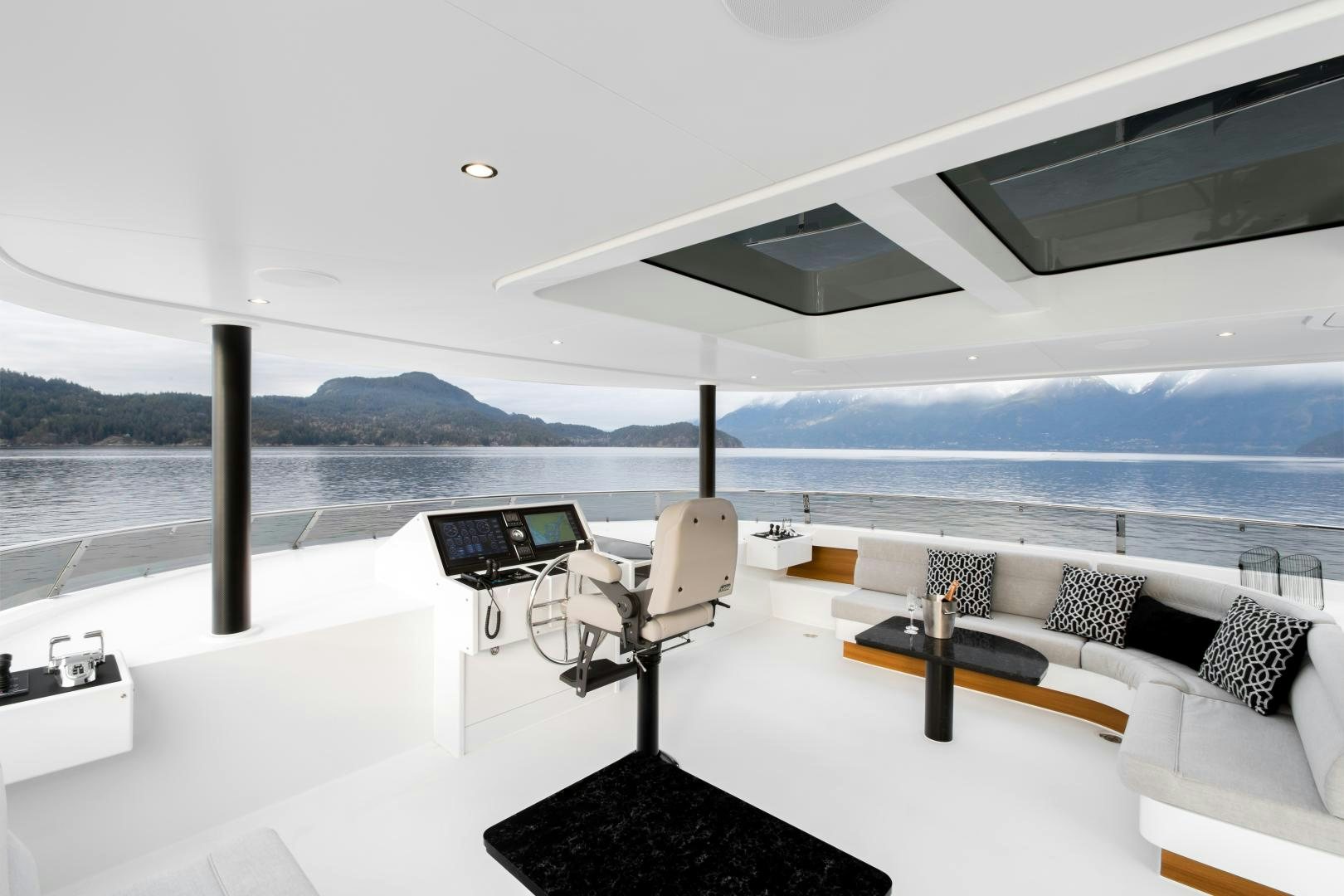 a room with a couch and a laptop on a table aboard CRESCENT 117 Yacht for Sale