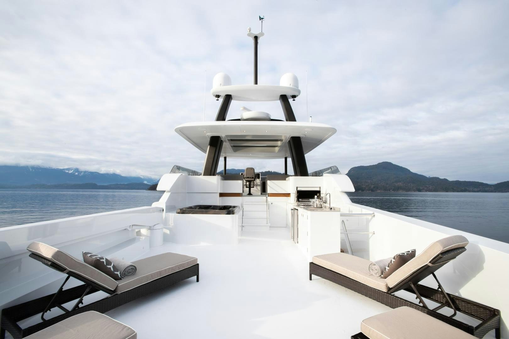 a white boat on a body of water aboard CRESCENT 117 Yacht for Sale