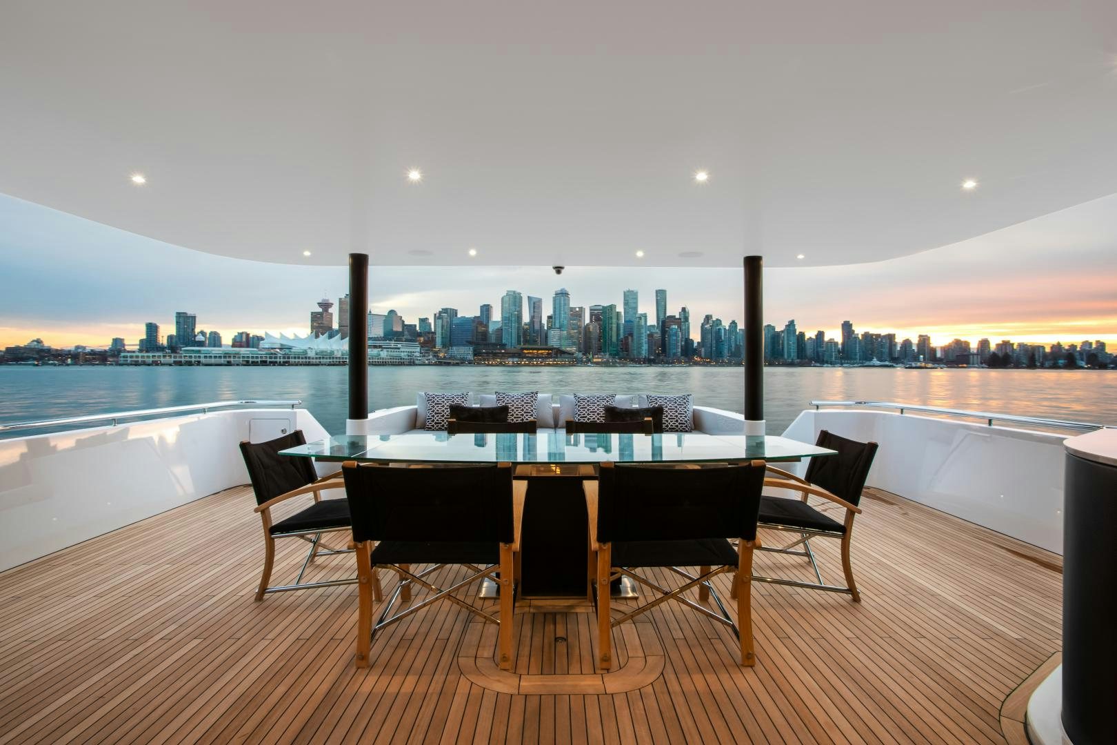 a table and chairs in front of a large city aboard CRESCENT 117 Yacht for Sale