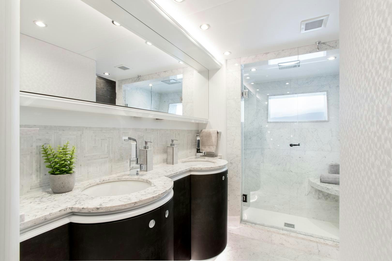 a bathroom with a large mirror aboard CRESCENT 117 Yacht for Sale