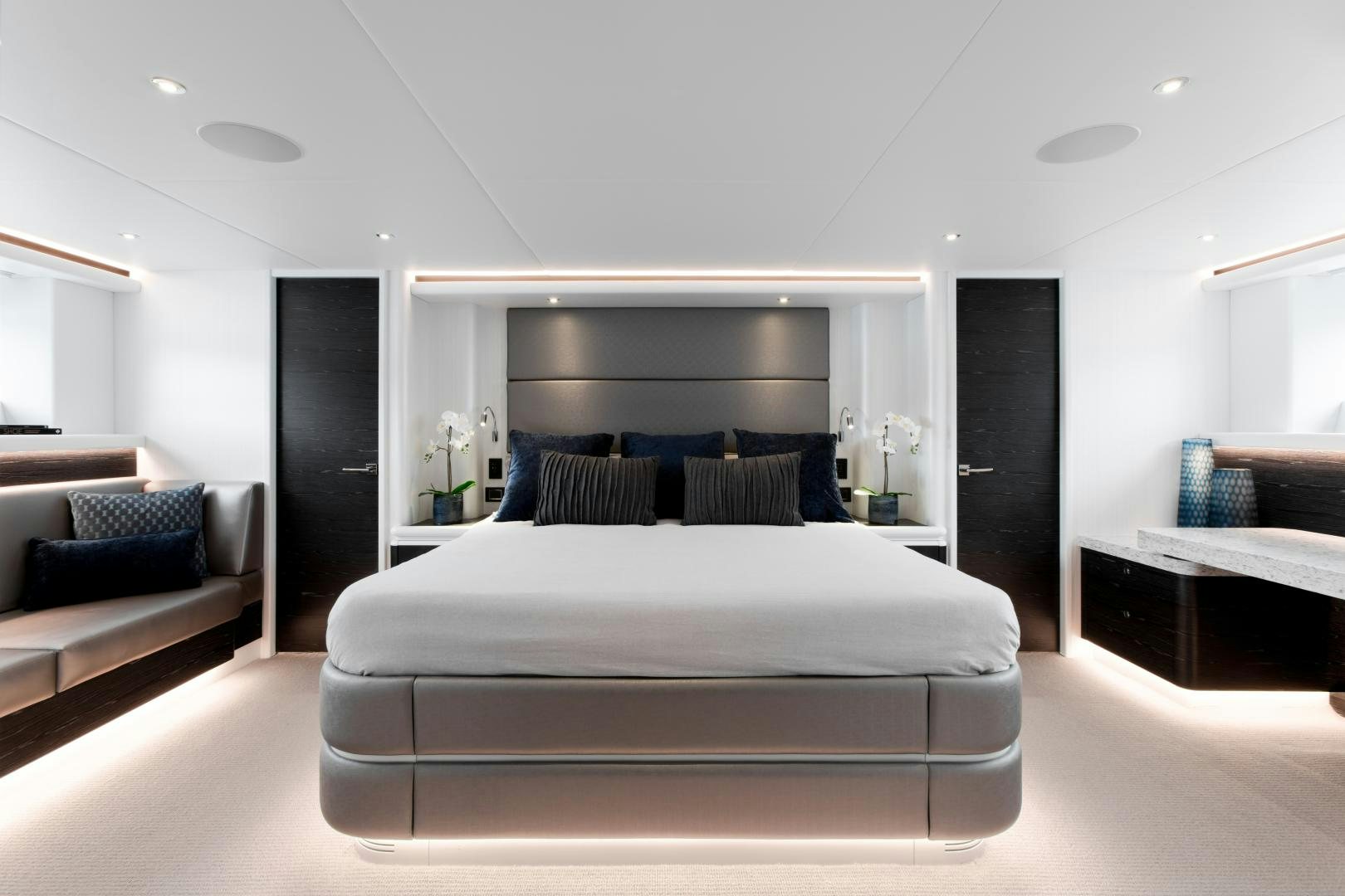 a white living room with a black door and a black door aboard CRESCENT 117 Yacht for Sale