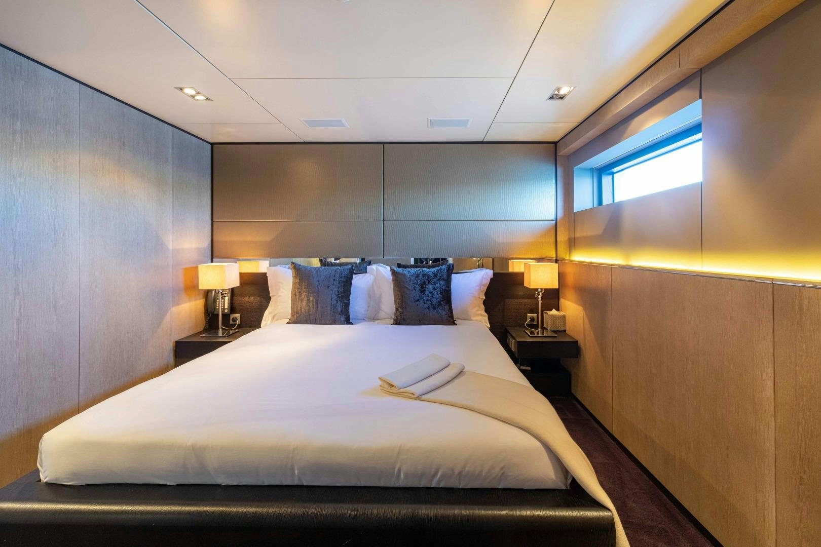a bed with a white sheet and pillows aboard TOMMY BELLE Yacht for Sale
