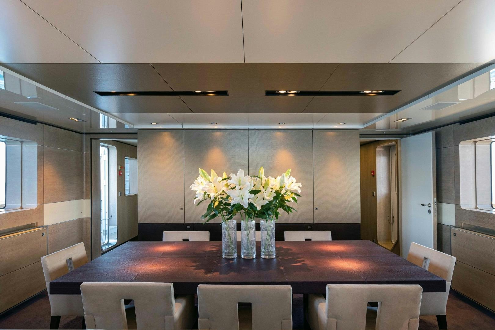 a table with flowers on it aboard TOMMY BELLE Yacht for Sale