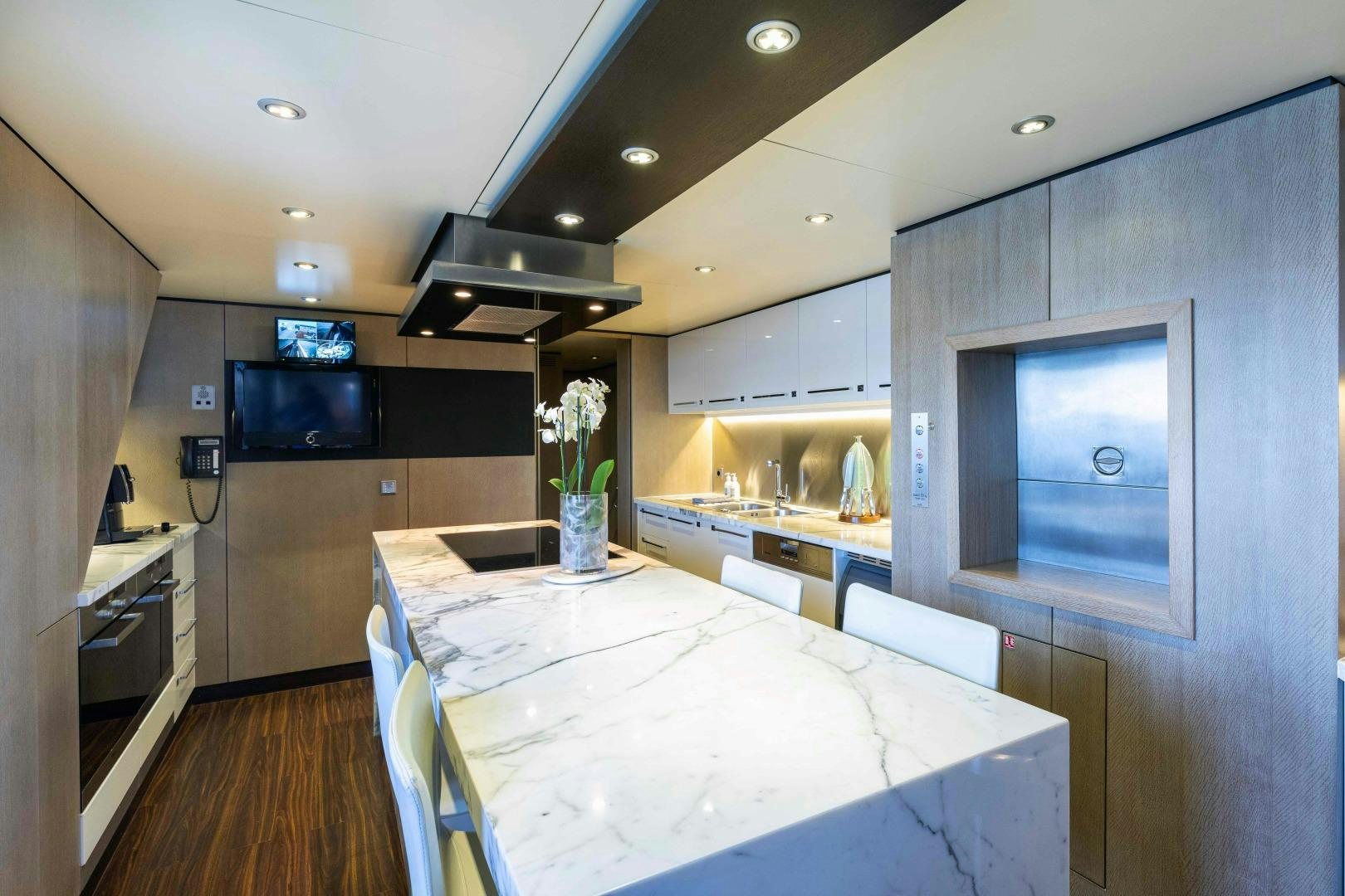 a kitchen with a large table aboard TOMMY BELLE Yacht for Sale