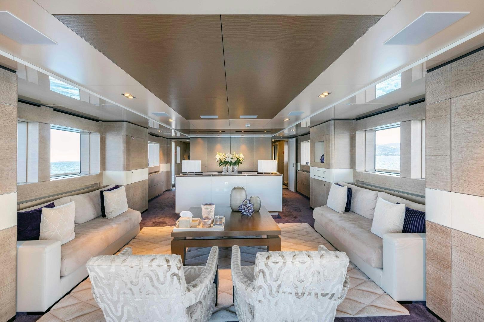 a living room with a couch and a table aboard TOMMY BELLE Yacht for Sale