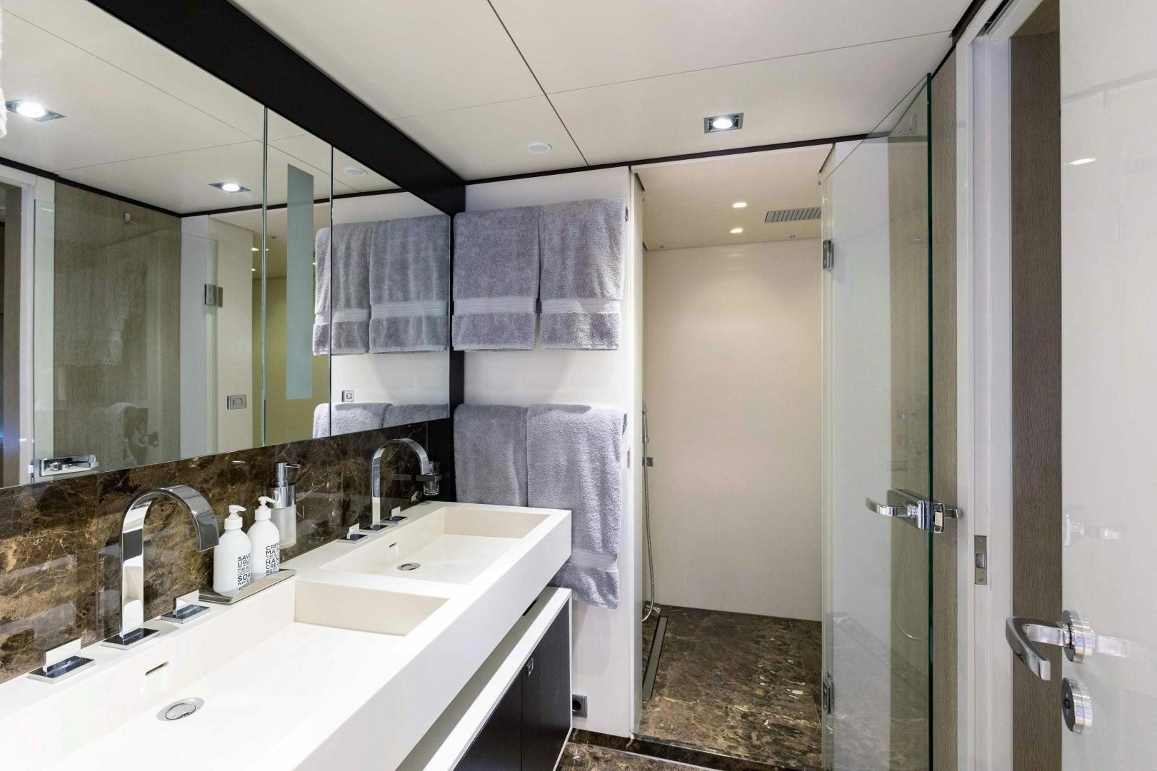 a bathroom with a large mirror aboard TOMMY BELLE Yacht for Sale