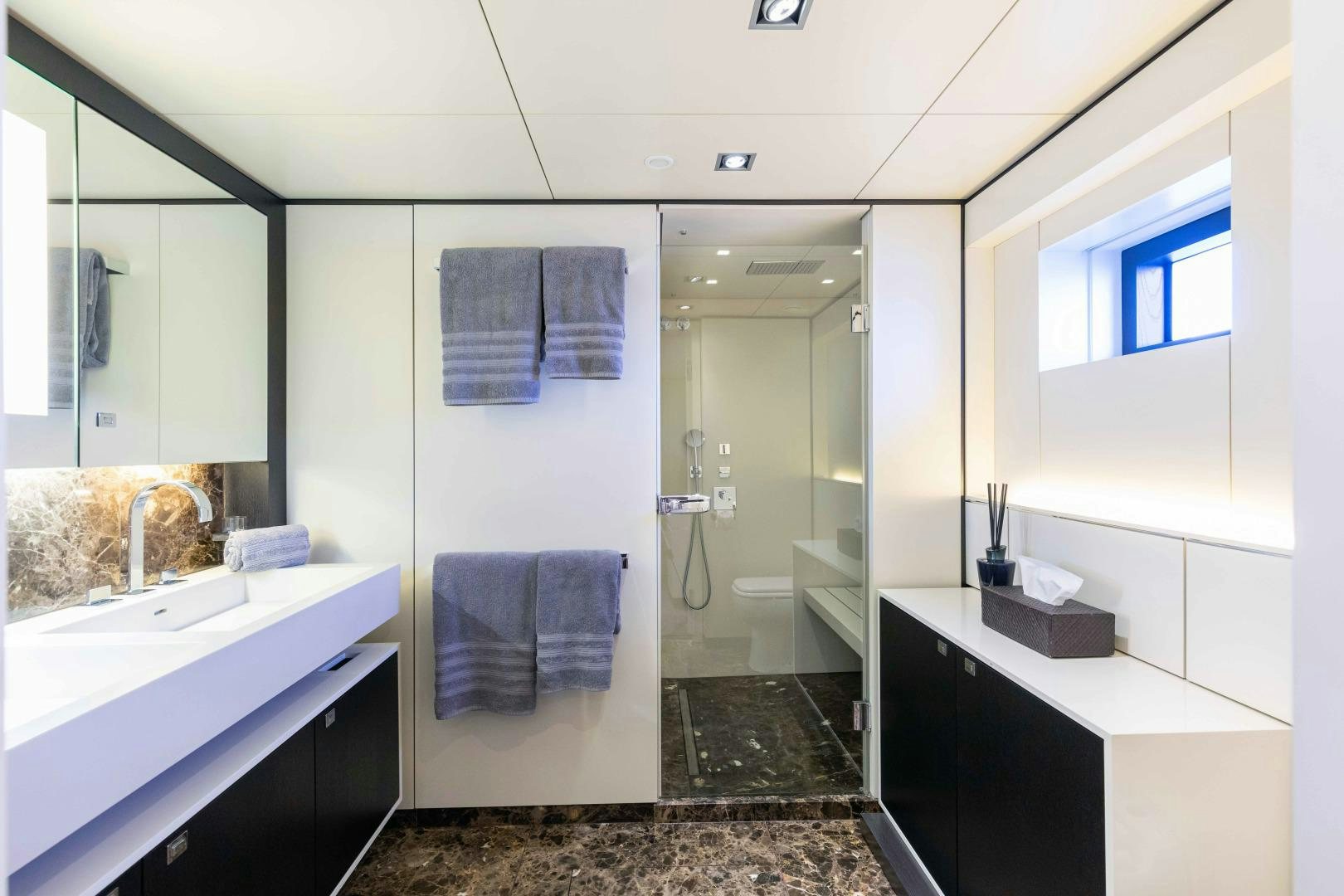 a bathroom with a glass shower aboard TOMMY BELLE Yacht for Sale