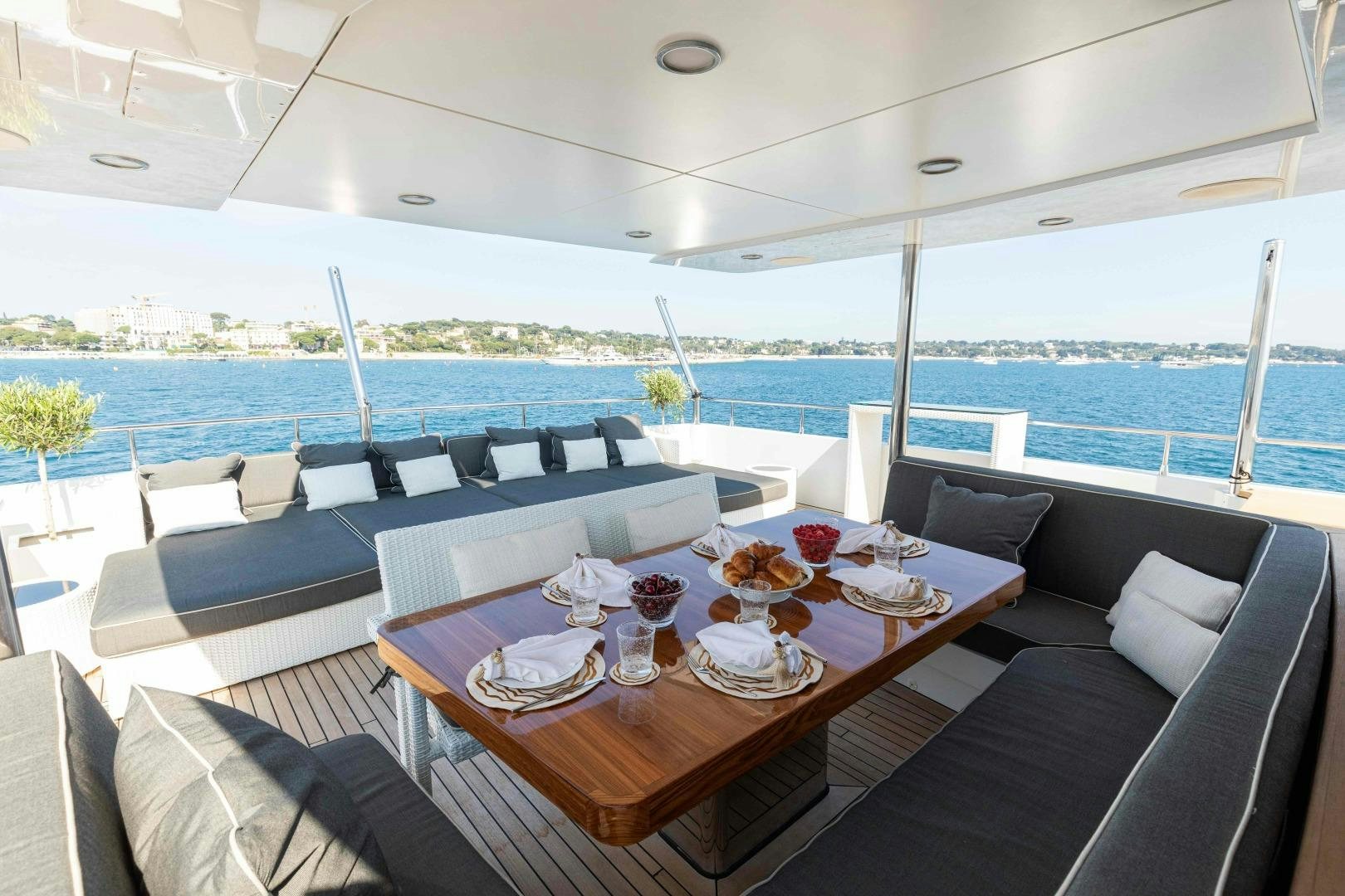 a table with chairs and a couch aboard TOMMY BELLE Yacht for Sale