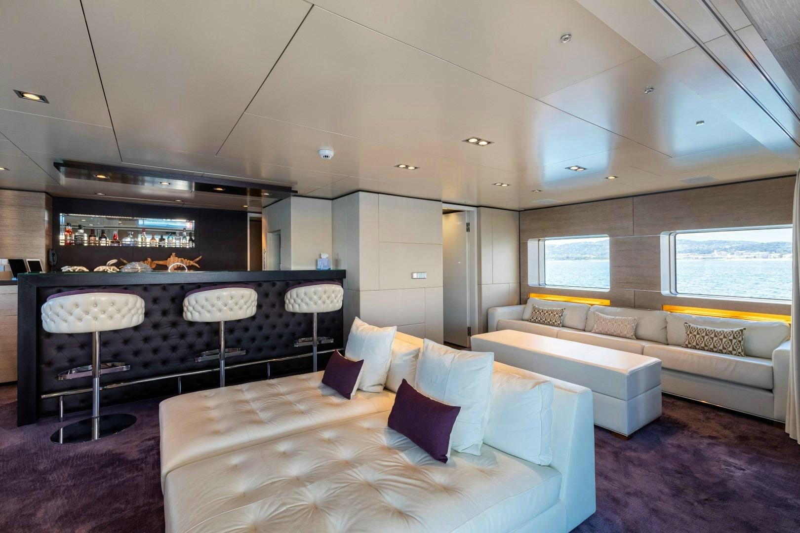 a living room with a couch and a table aboard TOMMY BELLE Yacht for Sale