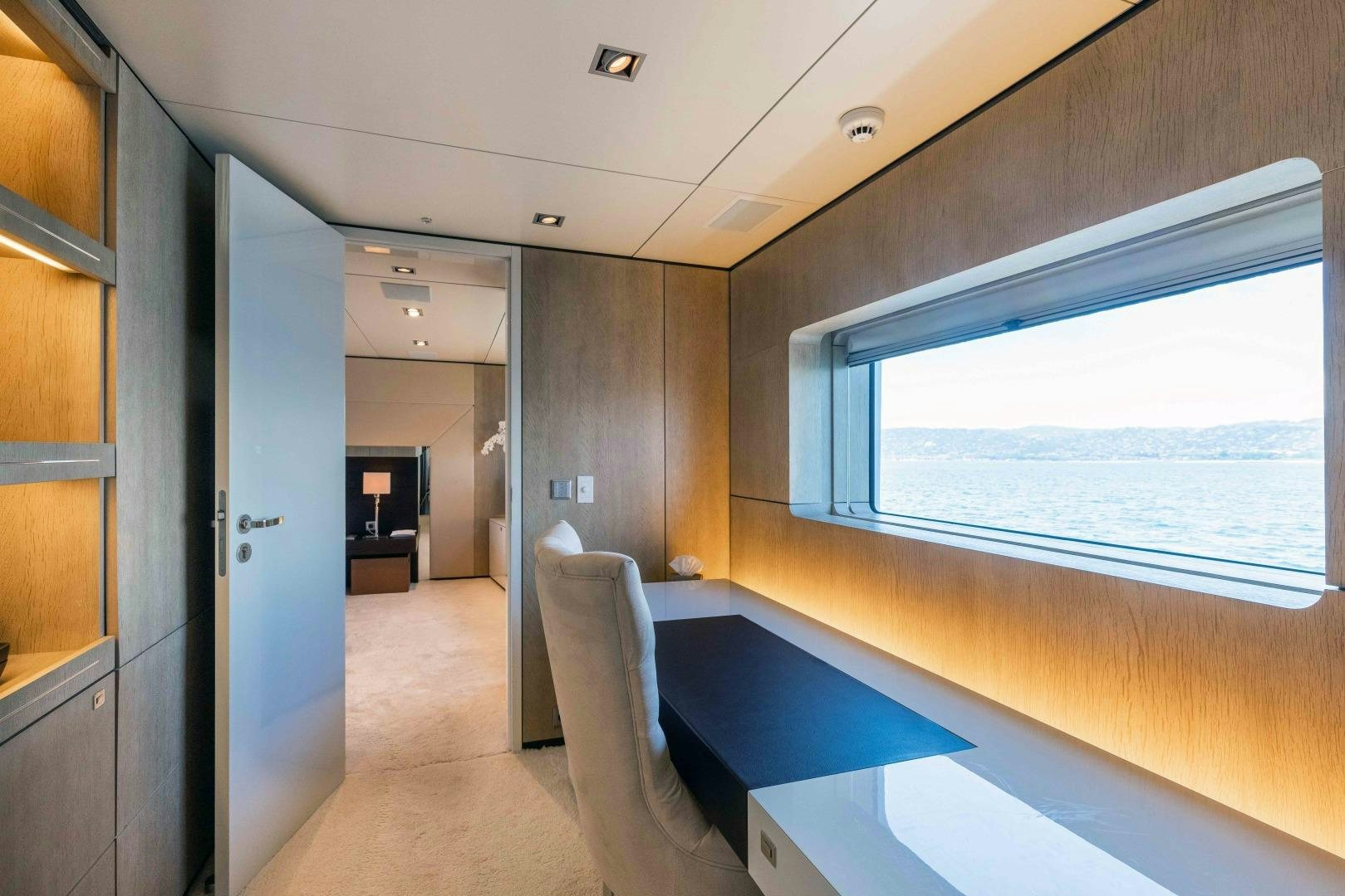 a room with a bed and a window aboard TOMMY BELLE Yacht for Sale