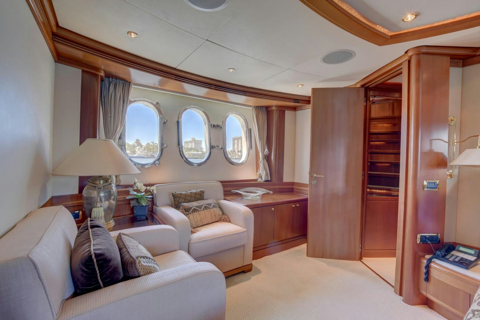 a living room with a mirror and a couch aboard SIN OR SWIM Yacht for Sale