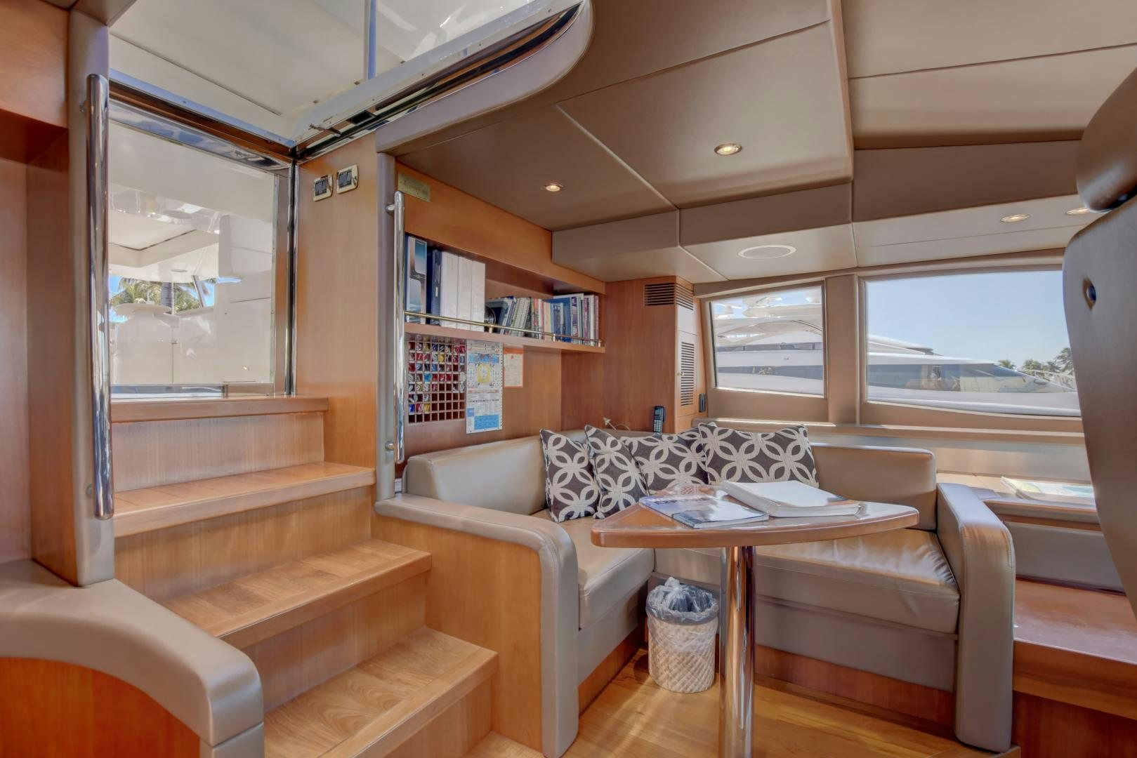 a living room with a couch and a table aboard SIN OR SWIM Yacht for Sale