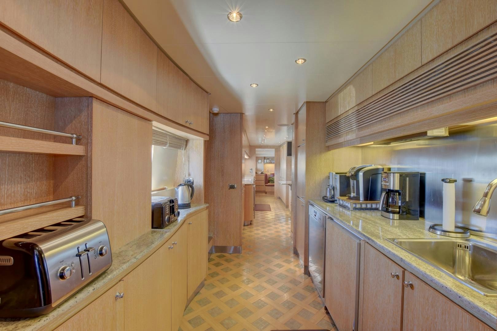 a kitchen with a sink and cabinets aboard SIN OR SWIM Yacht for Sale
