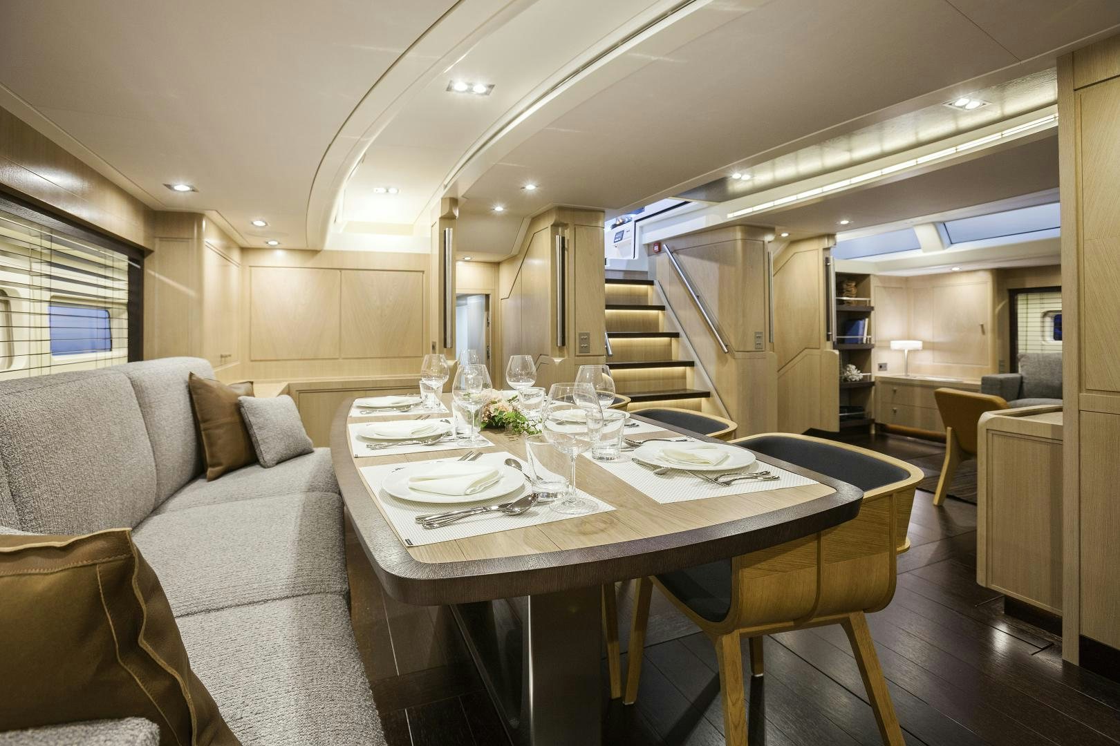 a large dining table in a living room aboard ODIN  Yacht for Sale