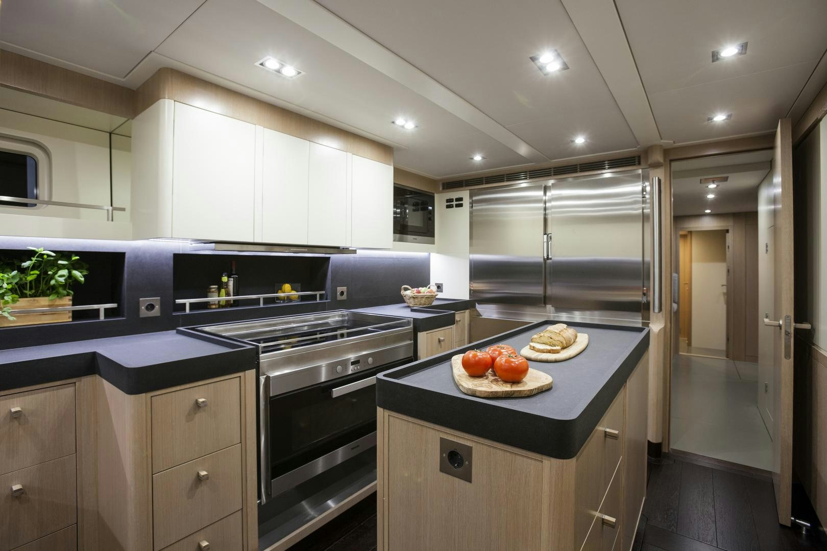 a kitchen with white cabinets aboard ODIN  Yacht for Sale