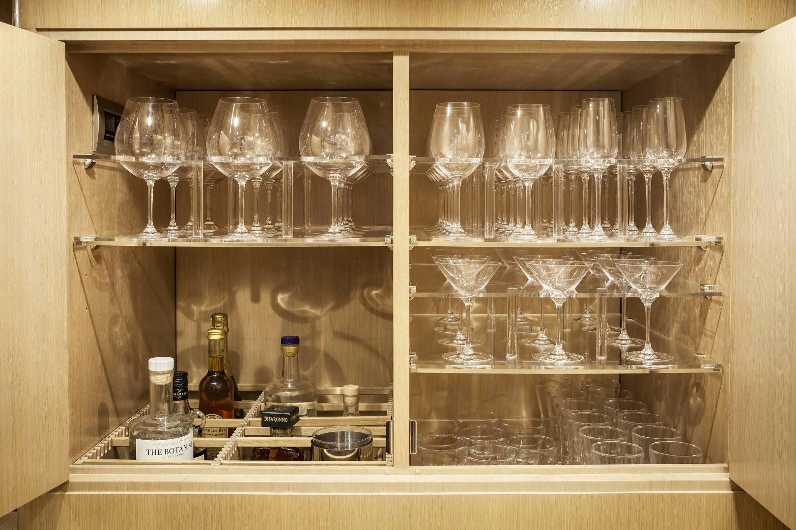 a glass cabinet with glasses and bottles aboard ODIN  Yacht for Sale