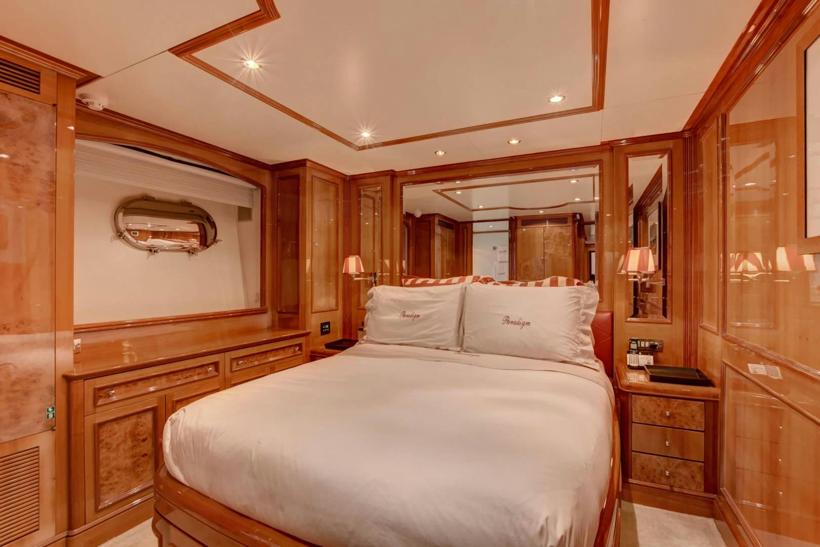 a bedroom with a bed and a mirror aboard PARADIGM Yacht for Sale