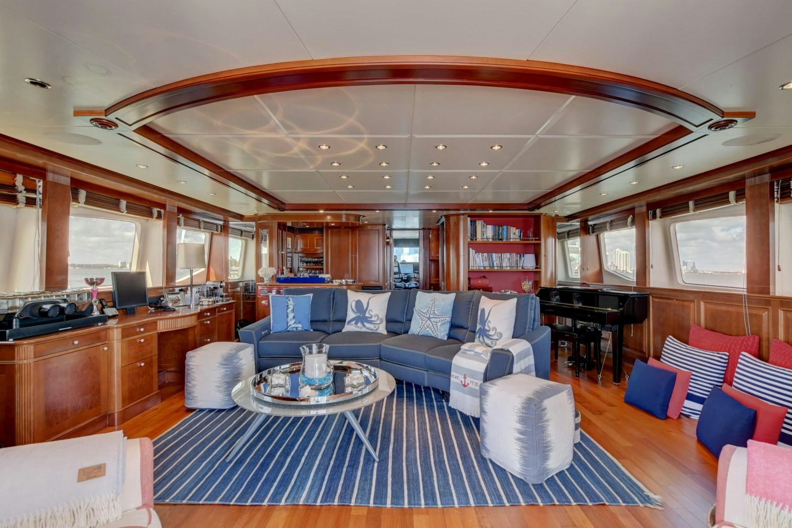 a living room with a blue rug aboard PARADIGM Yacht for Sale