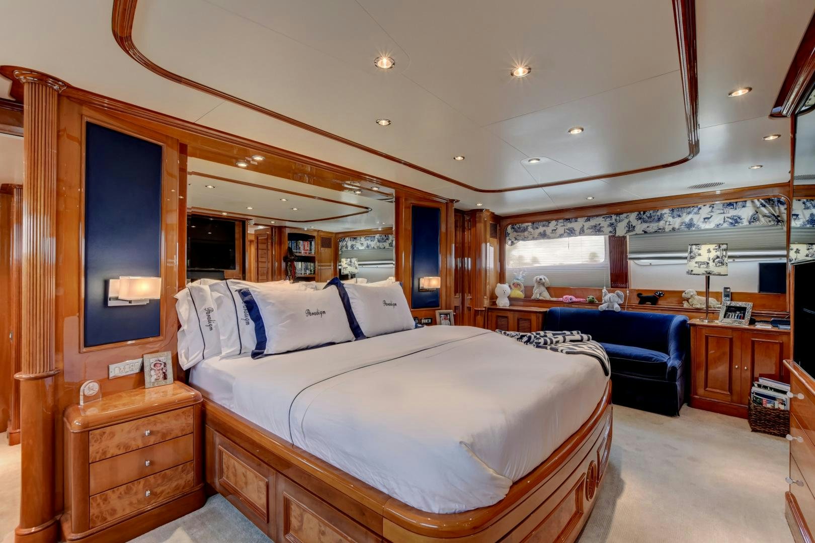 a bedroom with a bed and a desk aboard PARADIGM Yacht for Sale