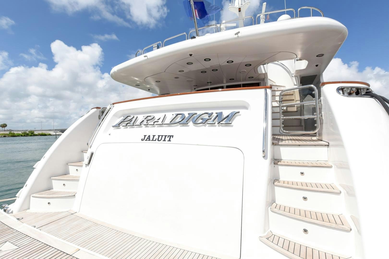 a white boat on a body of water aboard PARADIGM Yacht for Sale