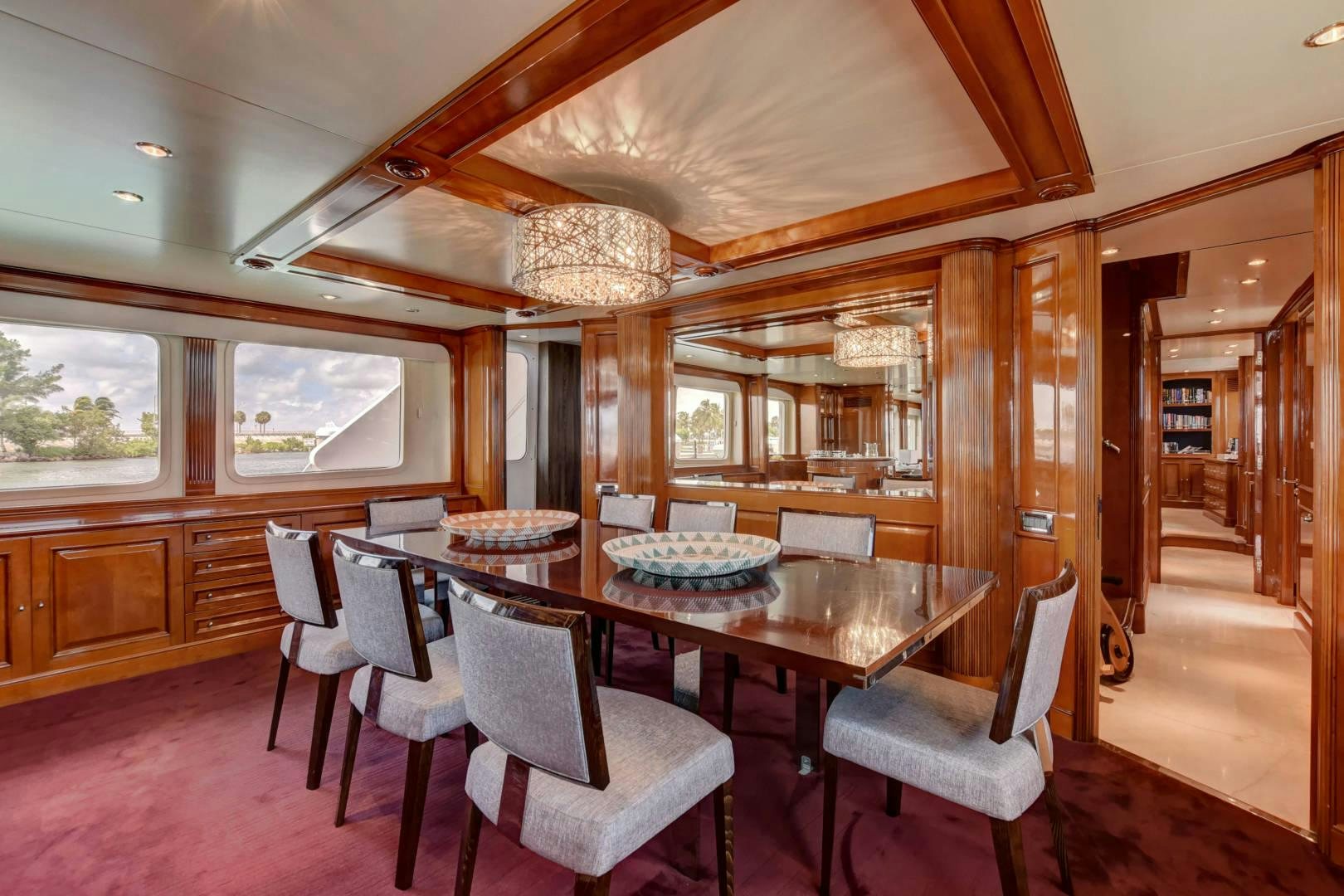a dining room with a table aboard PARADIGM Yacht for Sale