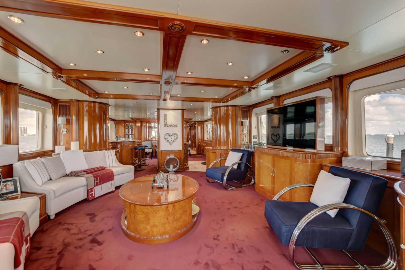 a living room with a table and chairs aboard PARADIGM Yacht for Sale
